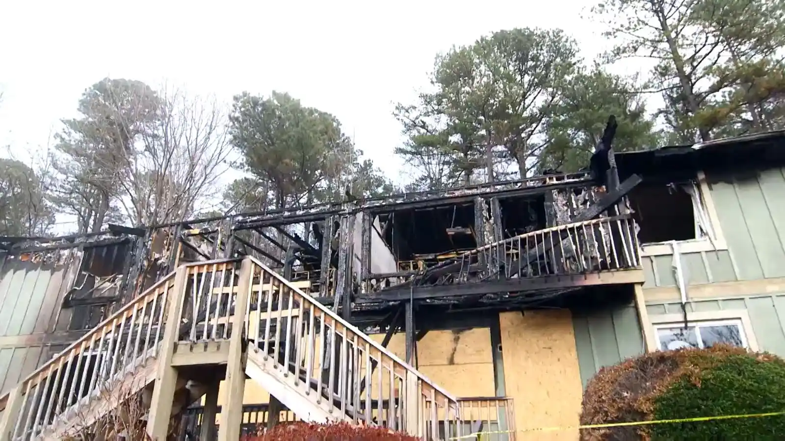 Exterior of a multi-unit building with visible fire and smoke damage