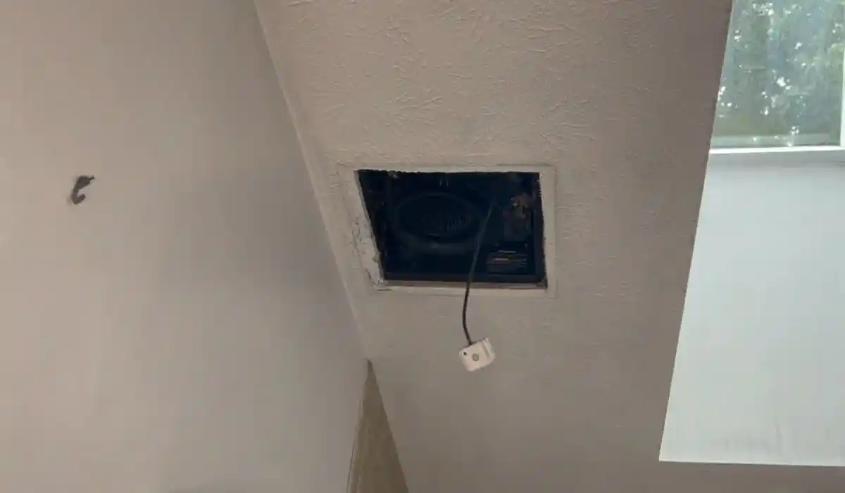 Access opening cut into a wall near the ceiling to inspect for smoke damage